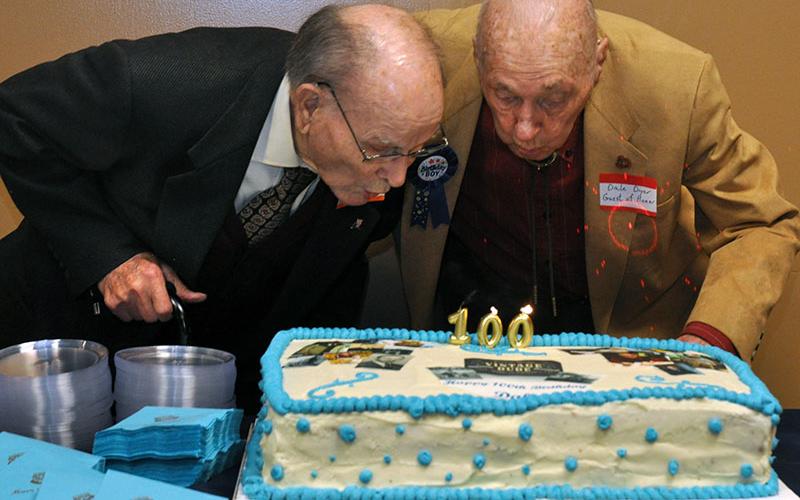 Fannin County historian Dale Dyer, right, blows out his birthday candles with long-time friend and fellow Bomber pilot, James Watkins. Both men are celebrating turning 100-years-old this December.