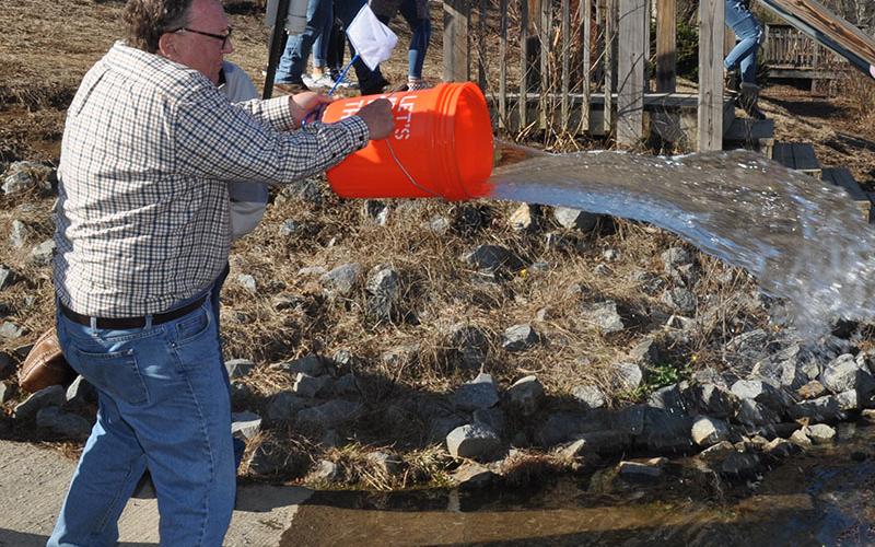 Trout Unlimited’s Carl Riggs tosses the few remaining trout fingerlings into the Toccoa river, December 18. The group partnered with Fannin County Middle School to learn about the trout life-cycle by raising them from eggs in the Trout in a Classroom