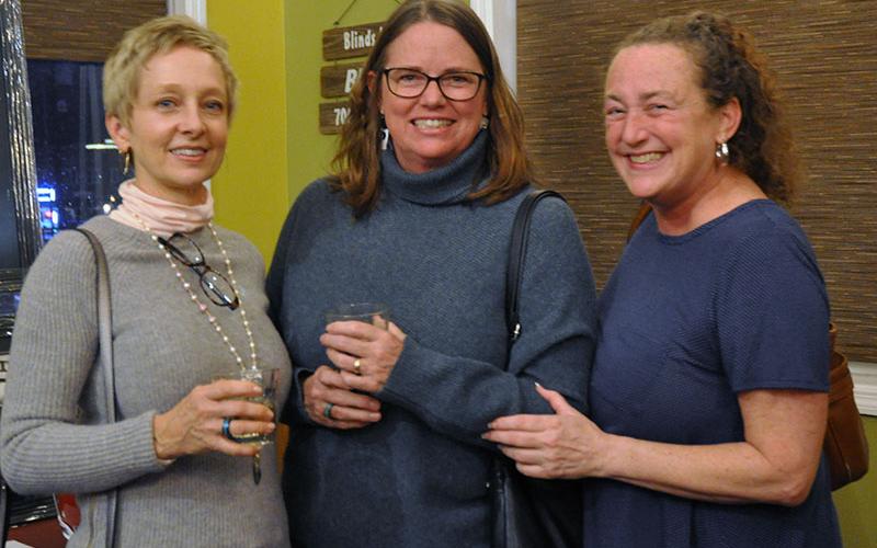 Freedom for Fido (FFF) supporters Sarah Gallaher, Anne Heikkila and Marsha Gano, shown from left, browse the silent auction items and enjoy the food and wine paring fundraiser hosted by Blue Jeans Pizza, December 10. FFF already has six families in line to receive fences in the new year. All proceeds go toward building fences.