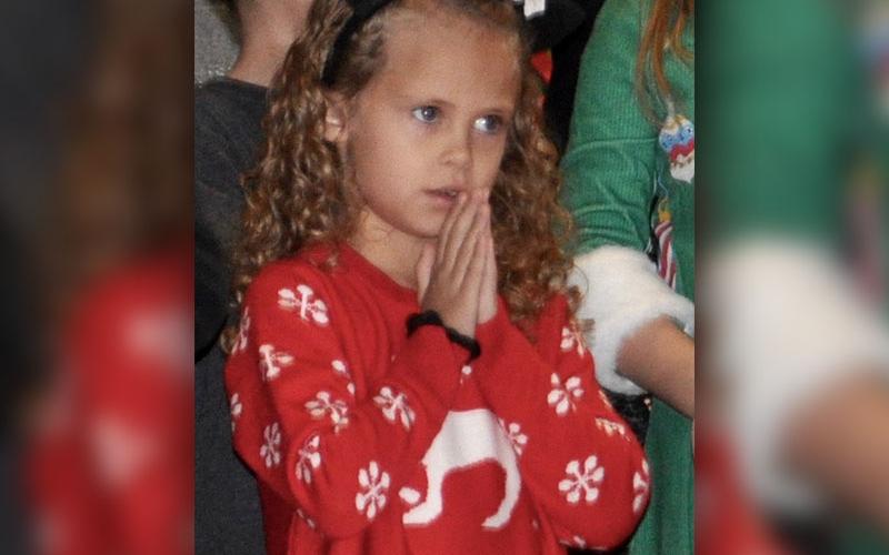 Little lamb Hailey Hawkins shows her praying hands while performing the Christmas classic “Go tell it on the Mountain.”