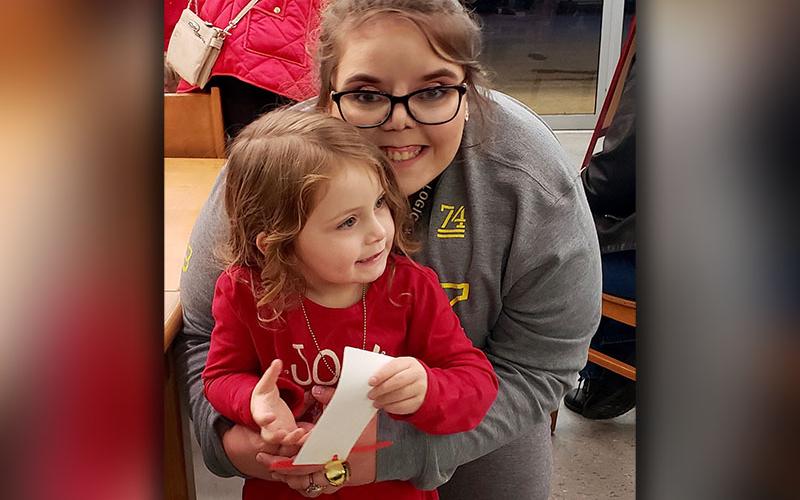 Erika Earl, back, and Carly were eager to hear the story of The Polar Express and enjoy some of the other activities such as snow making and ginger bread men coloring at East Polk Library in Ducktown Monday, December 9.