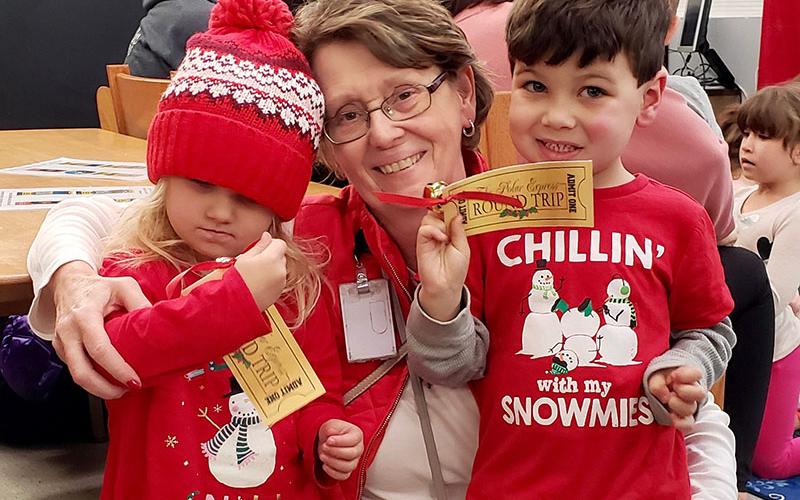 Amiyah Cioffi, left, and Easton Cioffi check out their golden tickets for The Polar Express at the East Polk County Library in Ducktown. They attended the special reading of the popular children’s book at the library Monday, December 9. Theresa Dillard was on hand to make sure they “boarded the right train.” More photos from the event can be found on A7. Also, a story and pictures from Dillard’s retirement reception at Fannin County High School can be found on A3.