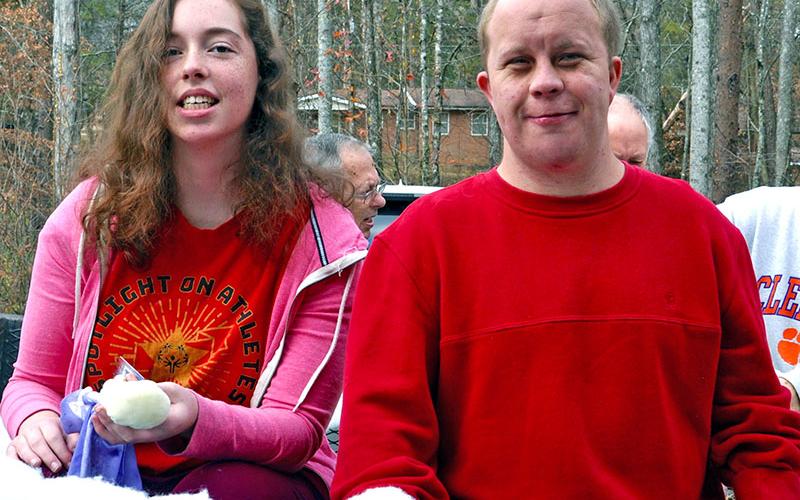 Ansley Price and Jay Jenkins smile while testing out the Fannin County Special Olympics float for the Light Up Blue Ridge Parade.
