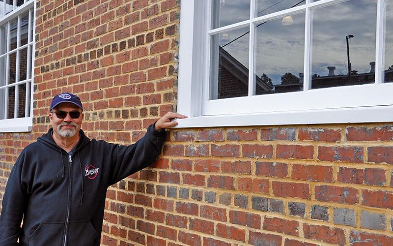 Rush shows off the new 12-paned windows that were custom built to replicate the original windows in the Hoist House.