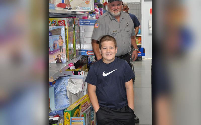 Lieutenant Tony Galloway with the Fannin County Fire Department helped Joshua Hughes pick out some toys during Shop With A Cop, sponsored by the Fannin County Sheriff’s Office.