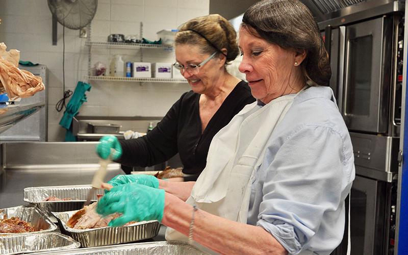 Barbara Davenport, front, and Mary Harmstom volunteered their time to prepare traditional Thanksgiving meals for The Good Samaritans of Fannin County’s Community Thanksgiving Open Table event, which took place Thursday, November 28.
