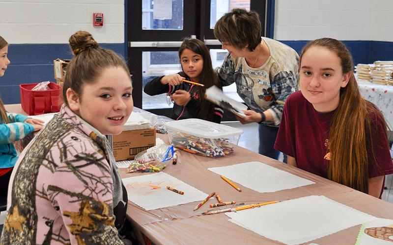 Girl Scouts Alyssa Marshall, left, and Kaleighann Ware created artwork to decorate The Good Samaritans of Fannin County’s Community Thanksgiving Open Table event.
