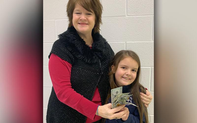 Mountain Area Christian Academy Rozlynne Spry donated $400 to the Patterson family who lost their home in a fire. Spry is shown with Pre-K Director DeGina Scoggins.