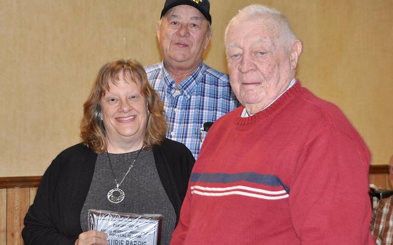 Paul Hunter, middle, and Joe Brandon recognized Laurie Barris at the Fannin County veterans organizations’ Christmas dinner for volunteering to drive community veterans to the VA hospital in the Disabled American Veterans van.