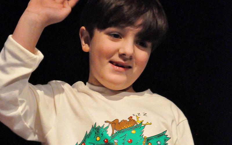 West Fannin Elementary School student Cayden Cantrell waved to his parents before he performed in the school’s White Christmas program.