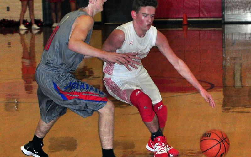 Evan Bobo tries to get around a defender in recent action for the Copper Basin Cougars basketball team.