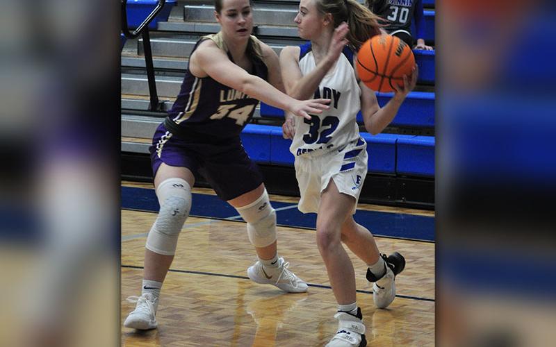 Lady Rebel Mackenzie Johnson passes out of a full court press in recent action for the Lady Rebels basketball team.