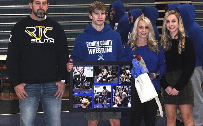 The Fannin County High School Rebel wrestling team recognized eight seniors before their match with Union County Tuesday, January 21. Shown from left are, Andrew Moreland, stepfather; senior Landon Galloway, Stephanie Galloway, mother; and Hailey Galloway, sister.