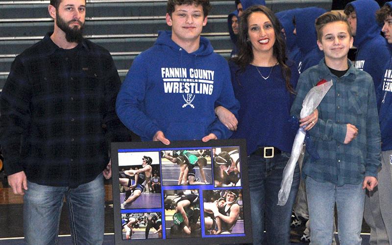 Malachy Johnston was one of eight senior wrestlers honored before Fannin County’s wrestling match with Union County Tuesday, January 21. Shown are, from left, Nathan Callihan, father; senior Malachy Johnston, Katy Callihan, mother; and Carson Callihan, brother.