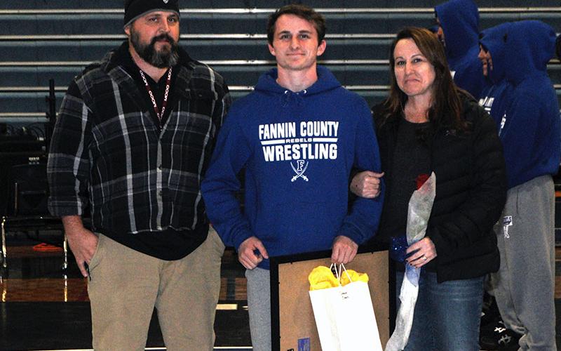 Rebel wrestler Connor Jones was recognized Tuesday, January 21, before the Rebels wrestling match against Union County. Jones is shown with his parents, Owen and Michelle Jones.