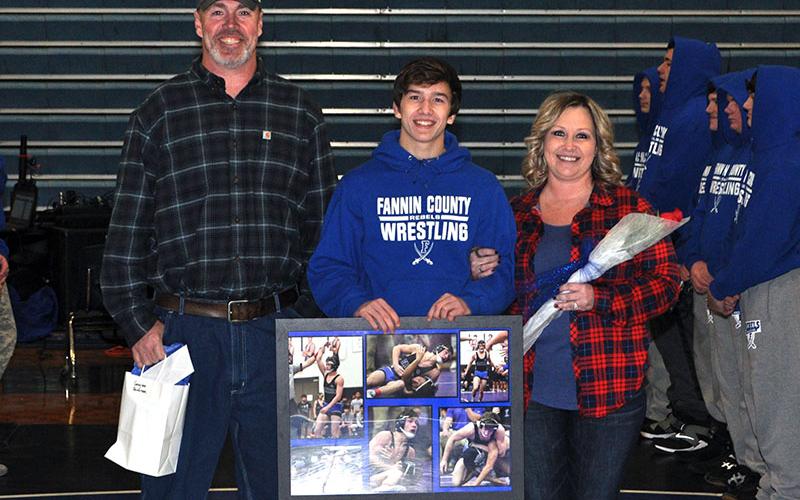 Grayson Patterson was one of eight Rebel wrestlers to be honored before Fannin County’s 60-16 win over Union County Tuesday, January 21. Patterson was escorted by Ronald Ledford and Heather Patterson.