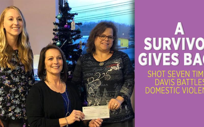 Domestic violence survivor Tina Davis, center, and her niece Tiffani Willingham, left, present North Georgia Mountain Crisis Network Executive Director Kimberly O’Neal with a check for $3,500 dollars. Davis donated half of the funds raised from Tina’s Cat Run, an annual 5K race, to the NGMCN to “help people in bad situations.”