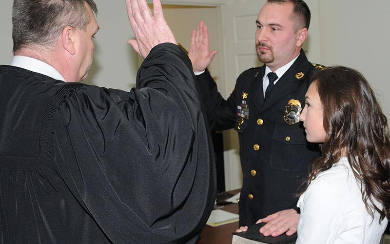 Mike Earley, right, was sworn in as McCaysville’s police chief after he was unanimously appointed to the position by the city council at its January 14 meeting. The ceremony was conducted by Fannin County Chief Magistrate Judge Brian Jones as Madison Earley held a Bible.