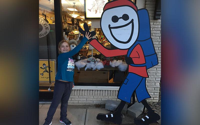 Elohi Law, a fifth grader at West Fannin Elementary, high fives the “Life is Good” guy in downtown Blue Ridge this past January.