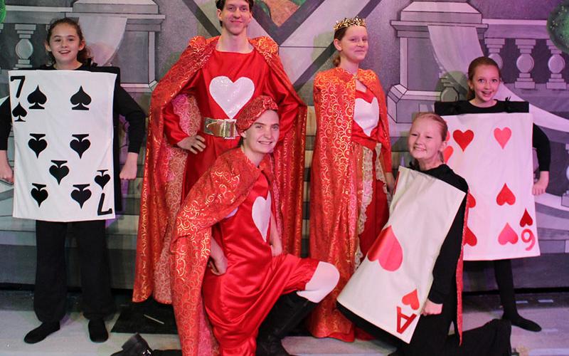 Don’t miss the action in BRCT’s “Alice in Wonderland,” performing now through February 9. Here, the King of Hearts (Xander Pasley, center left, standing) and the Queen of Hearts (Amelia Thomas, center right, standing) are surrounded by their subjects, the 7 of Spades (Maddie Boyce), the Knave of Hearts (Faith Mann, kneeling), the Ace of Hearts (Hannah Sheilds) and the 6 of Hearts (Abigail Shields).