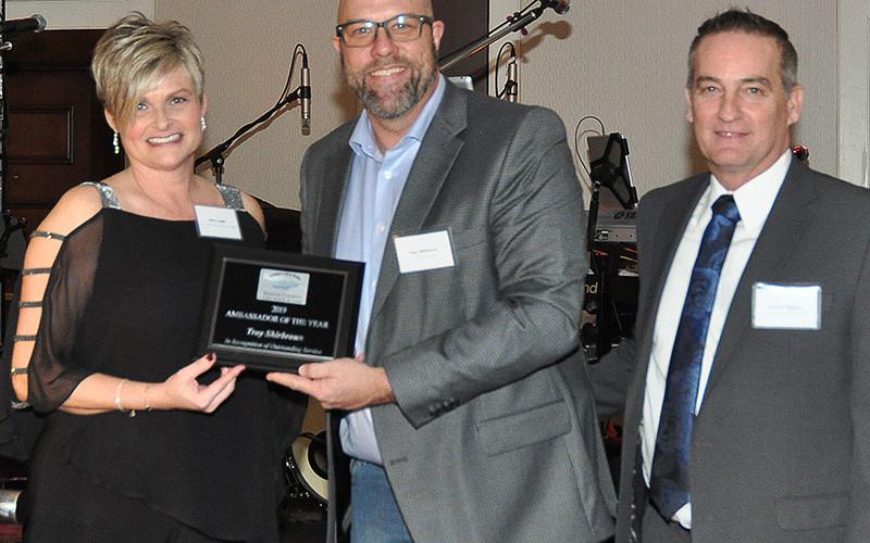 Fannin County Chamber of Commerce representative Stacy Lewis, left, and Chairman Frankie Ridgon, right, presented the Ambassador of the Year award to Troy Shirbroun at the chamber’s 36th Annual Banquet, January 25.