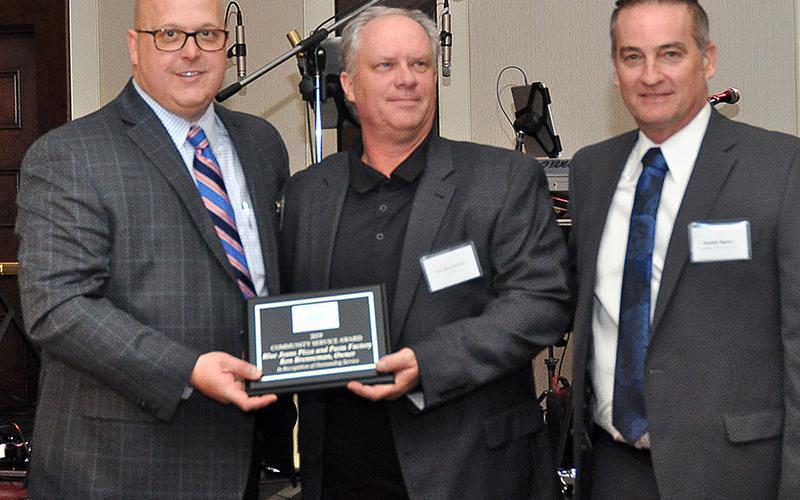 Fannin County Chamber of Commerce Chairman Elect Brandon Holloway, left, and Chairman Frankie Rigdon, right, presented Ken Brenneman with the Community Service Award at the chamber’s 36th Annual Banquet, January 25.