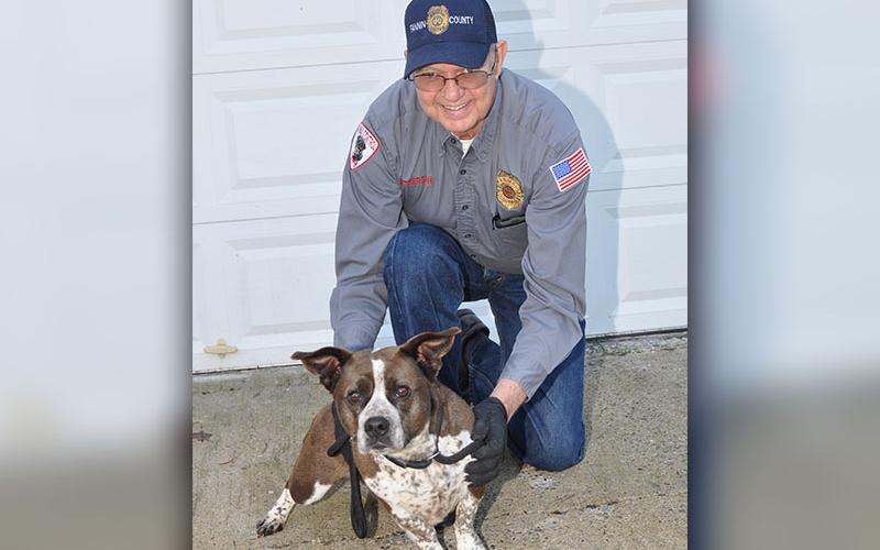 Fannin County Animal Control Officer Pat Patterson kneels next to this super cute Basset Hound mix. The female pup was dropped off at the facility January 13 and will remain there until adopted or transfered to a rescue. She has a short, smooth coat of hot chocolate and milk and boasts adorable stubby legs. View this sweetie pie under Animal Control number 016-20.