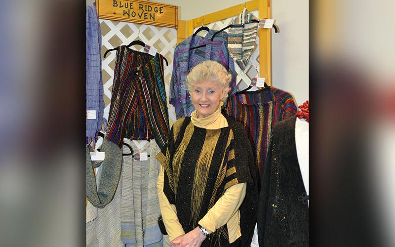 Fiber artist Roberta Thornton poses next to her art display in the North Georgia Autism Foundation’s new art gallery designed to employ folks on the autism spectrum.