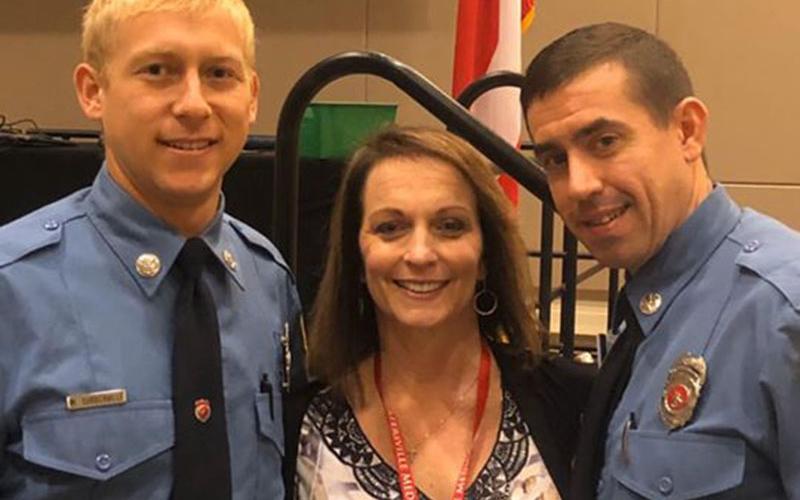 Tina Davis stands with two of the emergency services personnel who responded to Davis’ house when she was shot seven times by her estranged husband. Shown with Davis are, from left, EMT Michael Turberville and paramedic Billy Pflugrad.
