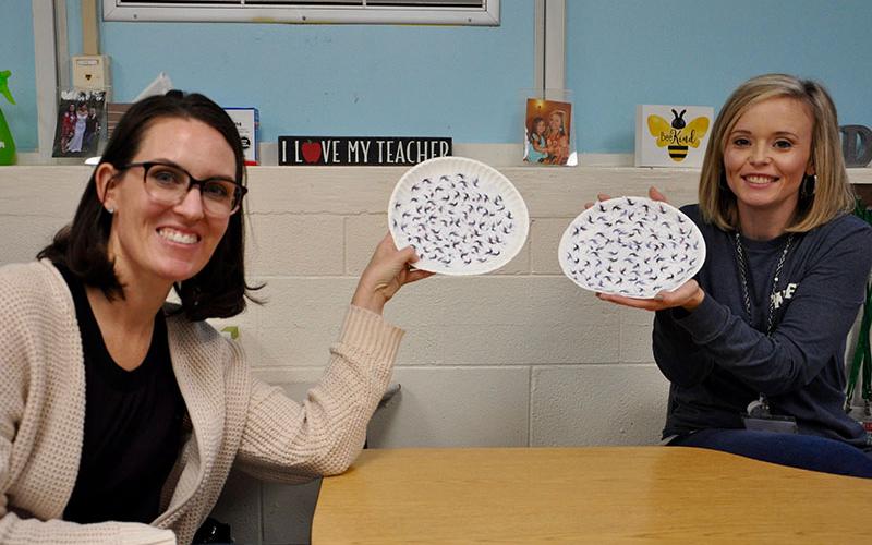Students were asked to do several activities pertaining to bats during an extensive lesson. Left, parent Jocelyn Miller and First Grade Teacher Katy Roberson show off some of the students’ work. The paper plates each have 200 mosquitoes glued on indicating the amount of mosquitoes that can be eaten by bats in a 20 minute time frame.