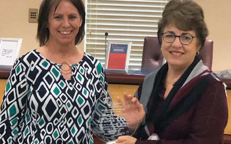 Appalachian CASA Executive Director Melanie Davis, right, presents the 2020 Appalachian CASA Volunteer of the Year award to Chris Martinez. Martinez has dedicated five years to the Appalachian Judicial Circuit as a Court Appointed Special Advocate (CASA).