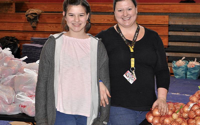 Copper Basin Elementary School allows community members to come and receive free groceries at their monthly food bank. Raegan, left, and Sarah Garner were among the many smiling faces to serve the Copper Basin Community Thursday, January 16.