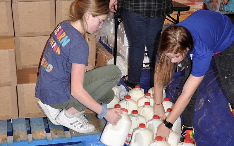 Volunteers grab some whole milk for Copper Basin community members Thursday, January 16.