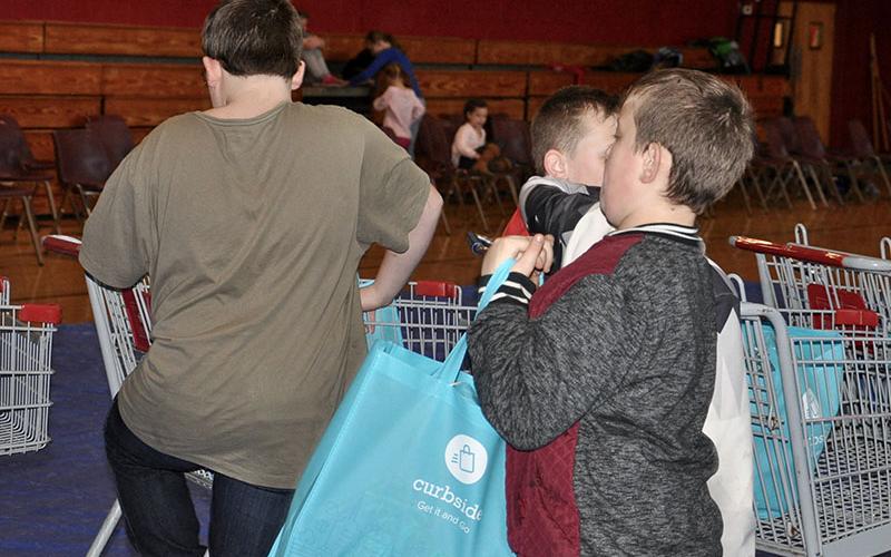 Young volunteers fill buggies and bags full of food for Copper Basin Elementary School’s (CBES) monthly food bank Thursday, January 16. CBES holds a food bank the third Thursday of every month.