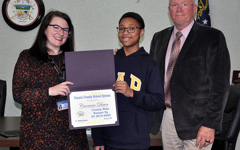 Fannin County Middle School Student Carnaceo Dixon, middle, was this year’s County Wide Spelling Bee runner up. He will serve as the alternate for Winner Kaylee Trotter at the regional competition. With Dixon is Director of Instructional Services and Policy Sarah Welch and Principal Keith Nuckolls.