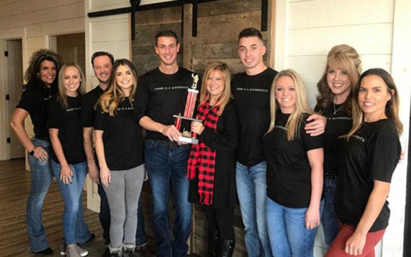Nathan Fitts &amp; Team with ReMax were the winners of First Community Mortgage’s Toys for Tots Challenge. Shown representing are, from left, Kristy Baugh, Hannah Watkins, Daniel Kaylor, Bethany Patterson, Nathan Fitts, Tracie Griffith, Grant Fitts, Blythe Dawson, Kimberly Burger and Brittany Patterson.