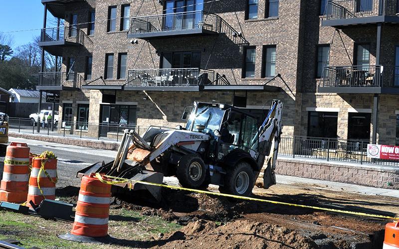 City of Blue Ridge employees work on changing out water lines, sewer lines and storm drains on West Main Street while blocking the street in front of the recently opened Blue Ridge Station Tuesday, December 31.