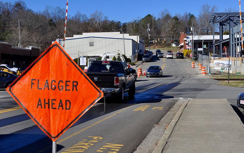 Cars navigate their way around the West Main Street construction that blocked one lane on Mountain Street in Blue Ridge. No flagger was present to direct traffic Tuesday, December 31, despite lane obstructions.
