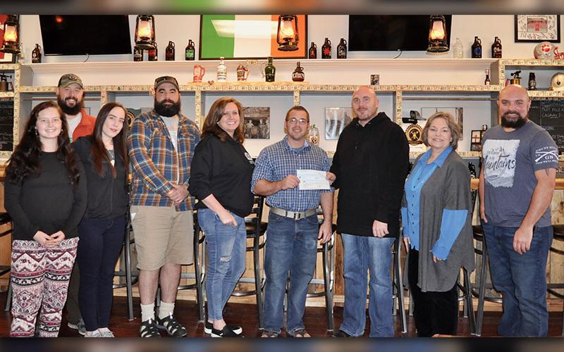 Copperhill Brewery raised $3,000 and River Laurel Gifts &amp; Boutique raised $500 for the Fannin County Family Connection Food Pantry during the holiday season. Shown during the check presentation are, from left, Caroline Allen, Joe Bugg, Mika Bowser, Alan Reis, Pamela Abbott, Food Pantry Manager Greg Gelp, Harrison Abbott, Family Connection Executive Director Sherry Morris and Macho Liberti.