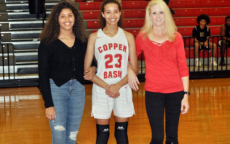 Copper Basin High School celebrated eleven basketball and cheerleading seniors in between games Tuesday, February 18. Brackett is shown with her sister, Ashleigh Brackett, and her mother, Amber Martin.