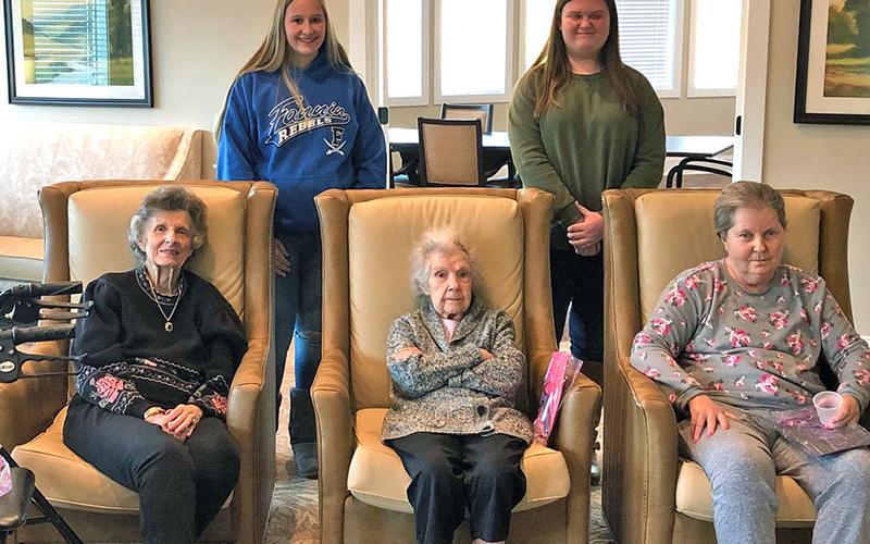 Fannin County High School students, Anna Rhodes and Gracie Stewart, performed research about the positive impact that music therapy has on the elderly population. Shown with the residents at Blue Ridge Assisted Living and Memory care are, from left, front, Georganna Johnson, Alice Lundgren and Brenda Johnson; back, Rhodes and Stewart.