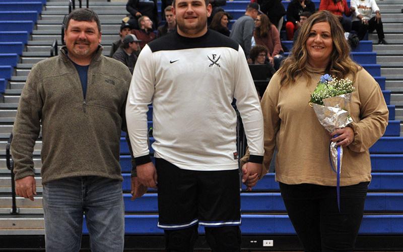 Senior Rebel Miles Johnson was one of eight seniors recognized during Fannin County’s last home basketball game of the season Friday, January 31. Johnson is shown with his parents, Earl Johnson and Leslie Mann.