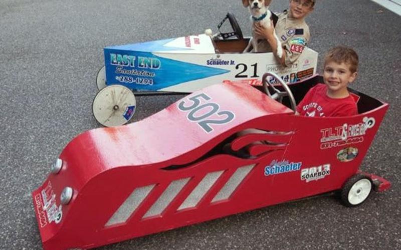These boys and their best friend, of the canine variety, test out the Blue Ridge Soap Box Derby cars they built for last year’s race. This year’s race is April 25.