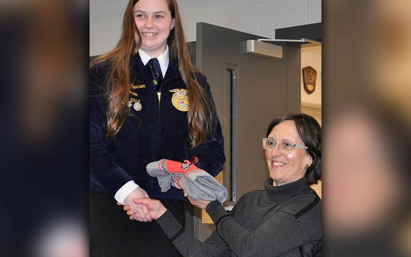 The Fannin County Young Farmer’s Association recognized several individuals at the organization’s annual banquet Friday night, February 7. Young farmer and high school senior Layne Epperson was recognized as a valuable asset and was awarded a 2020 membership to the Fannin County Young Farmer’s Association as well as a t-shirt. Presenting the shirt is 2019 Secretary Theresa Wollschlager.