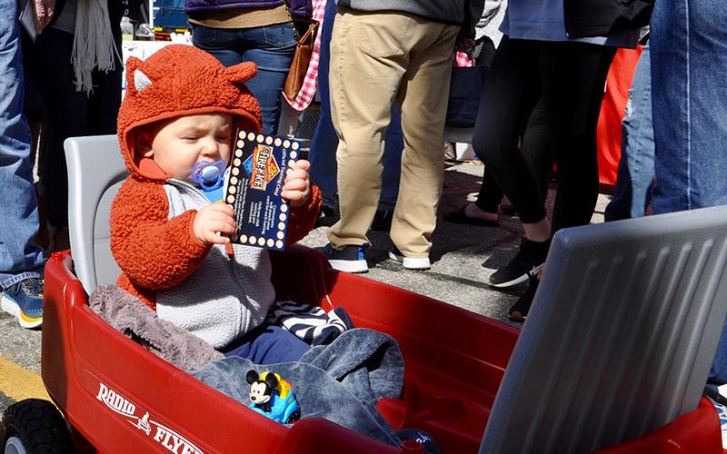 Little Noah inspects his chili card, while being hauled in a red wagon during Blue Ridge’s Fire &amp; Ice Chili Cook-Off and Craft Beer Festival.