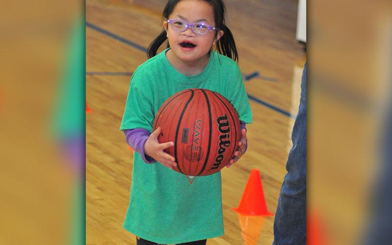 Lydia Shamblin smiles as the crowd cheers her on during the dribbling competition at Fannin County Special Olympics basketball competition Friday, January 31.