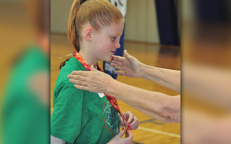 Abbie Dillard smiles as she recieves a first place medal during the Fannin County Special Olympics basketball competition Friday, January 31.