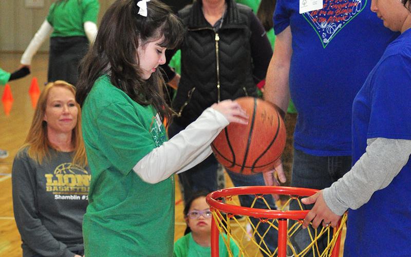 Autumn Hughes sinks a basket during the Fannin County Special Olympics basketball competition Friday, January 31, at the Fannin County Recreation Center.