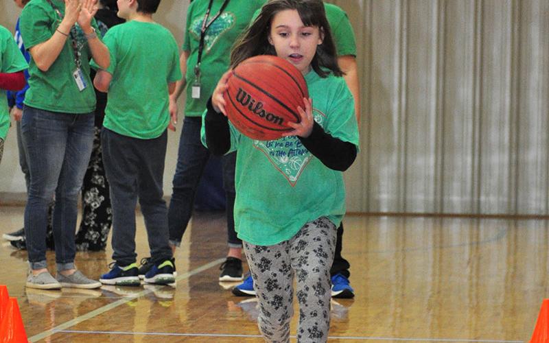 Special Olympics athlete Christina Evans races for the best time during a drill at the Fannin County Special Olympics basketball competition Friday, January 31.