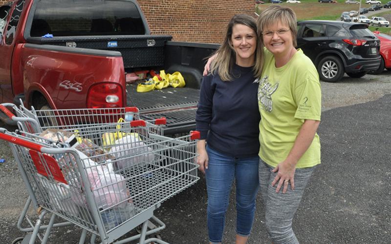 Wendy Bradburn, left, and Angela Deal pitched in to do their part at the Hoist House.